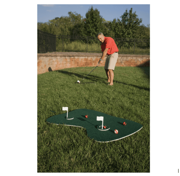 A man is playing a game of Blue Wave Aqua Golf Backyard Game in his backyard.